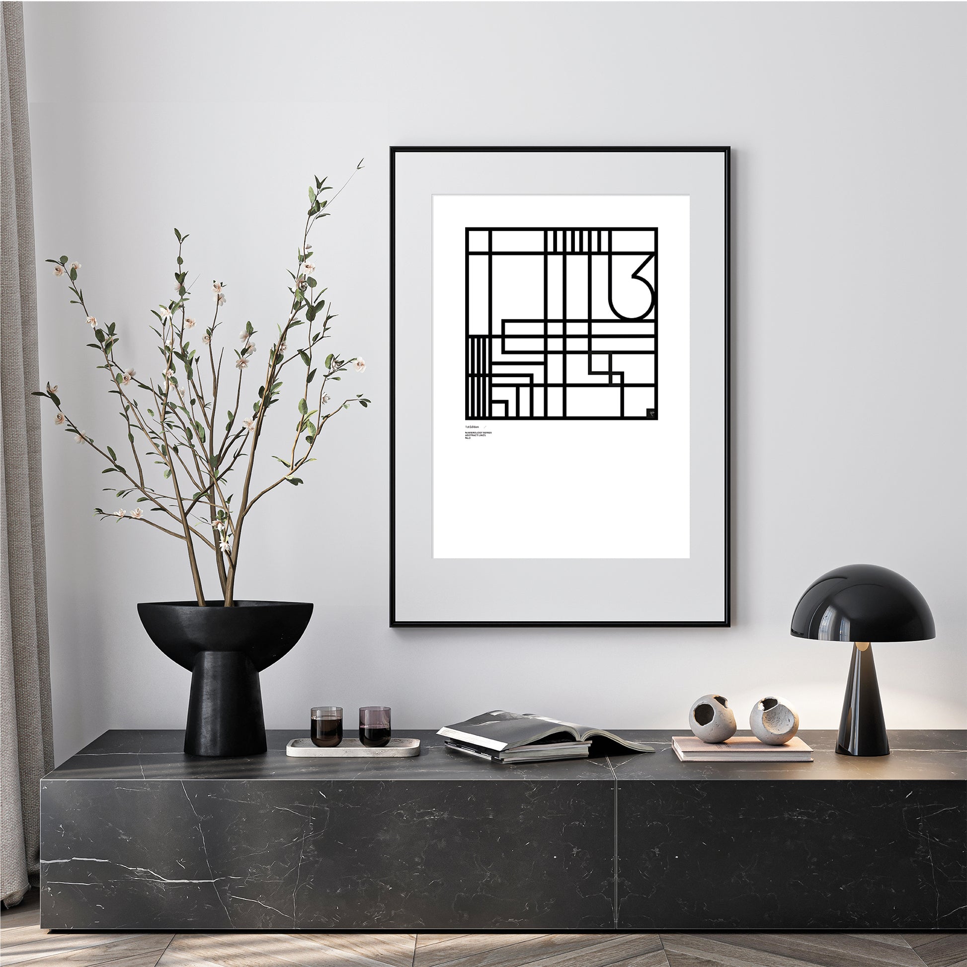 Modern interior with a black and white Numerology No.3 abstract limited Edition framed print on a gray wall.
